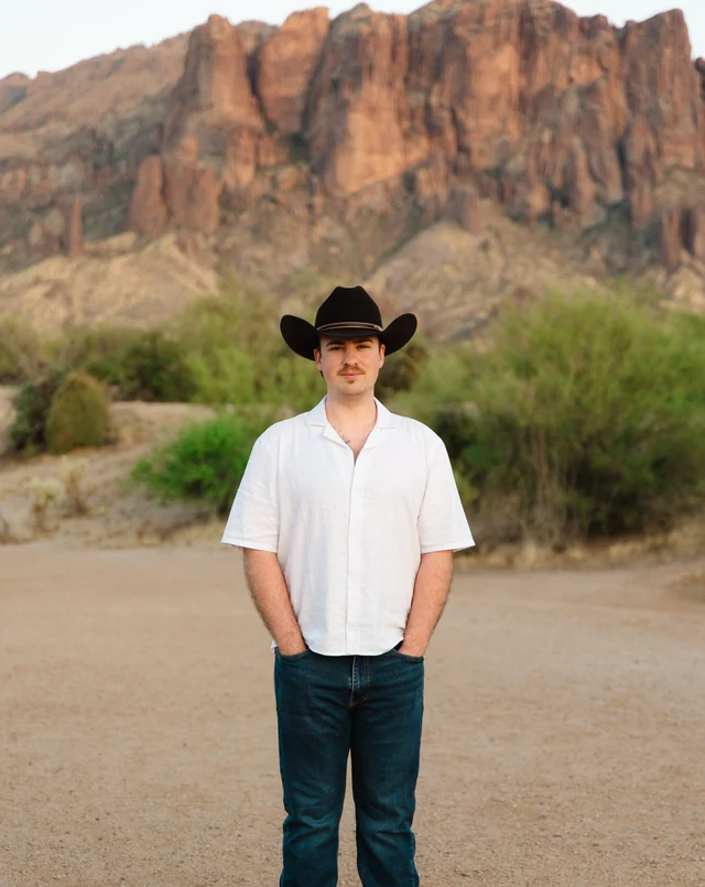 Trevor Unland outdoors in a black cowboy hat